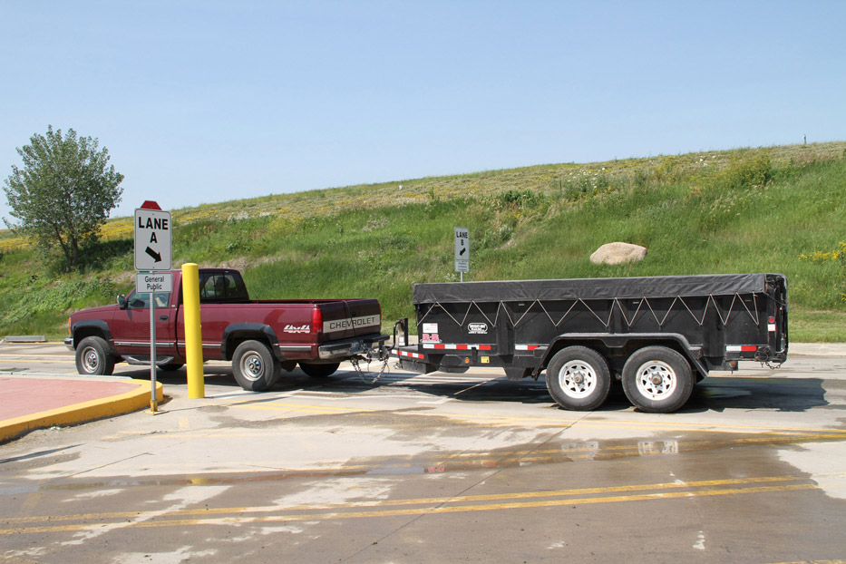 A covered trailer delivering trash